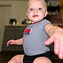 Noah joined the competition — help win amazing prizes! baby, child, infant, onesie, striped_clothing, fire_truck, blue_eyes, sitting, reaching_hand, indoor, floor, portrait, cute, happy, smiling, chubby_legs, close_up, home, blurry_background, person