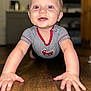 baby, crawling, floor, wooden_floor, smiling, happy, child, striped_shirt, red_trim, indoors, person, cute, young_child, cheerful, portrait, hands, face, blue_eyes, short_hair, close_up