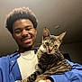 Billie joined the competition — help win amazing prizes! person, smile, cat, tabby_cat, indoor, watch, blue_shirt, chain_necklace, facial_hair, hairstyle, pet, feline, animal, happy, portrait, holding, fur, whiskers, eyes, friendship