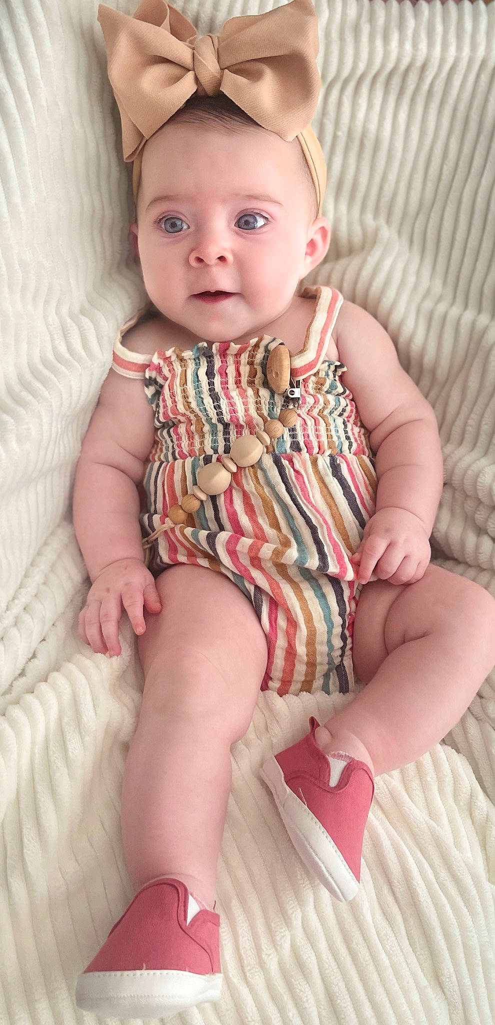 Mila is registered to the contest to win money with this photo: baby, baby_toddler_clothing, cheek, child, chin, collar, comfort, eye, face, finger, head, iris, lip, nose, pattern, person, pink, skin, sleeve, stomach