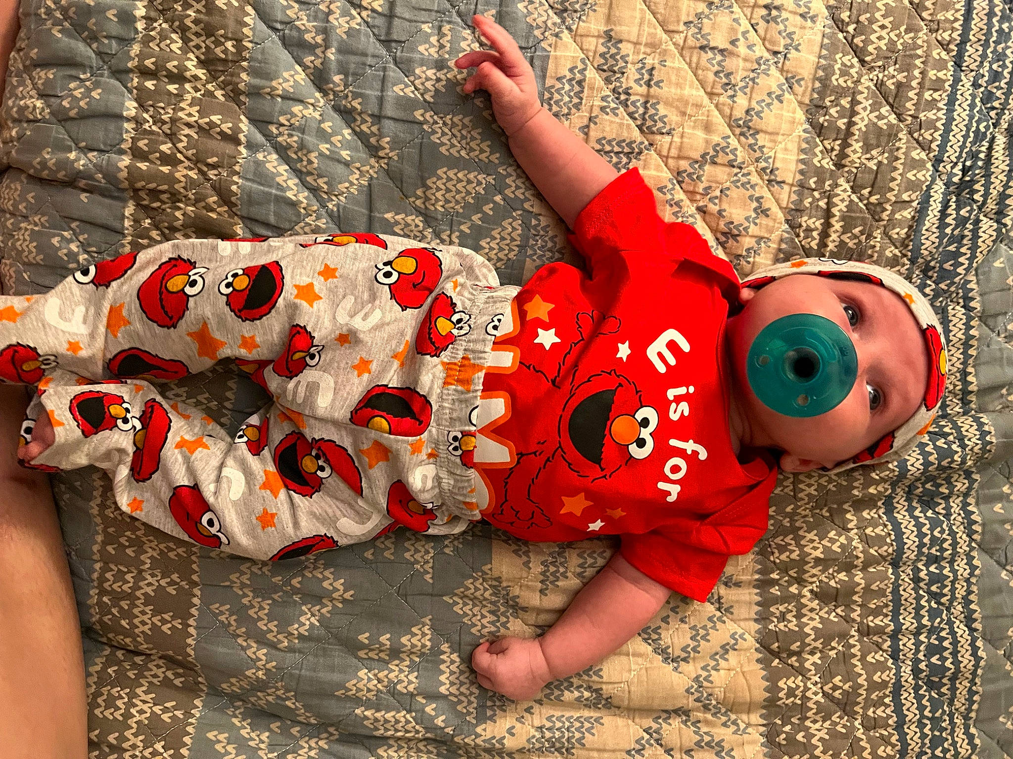 Shelby is registered to the contest to win money with this photo: baby_toddler_clothing, carmine, child, fashion_accessory, foot, fun, grass, happy, human_leg, leisure, orange, organism, pattern, person, plant, sitting, t_shirt, thigh, toddler, toy