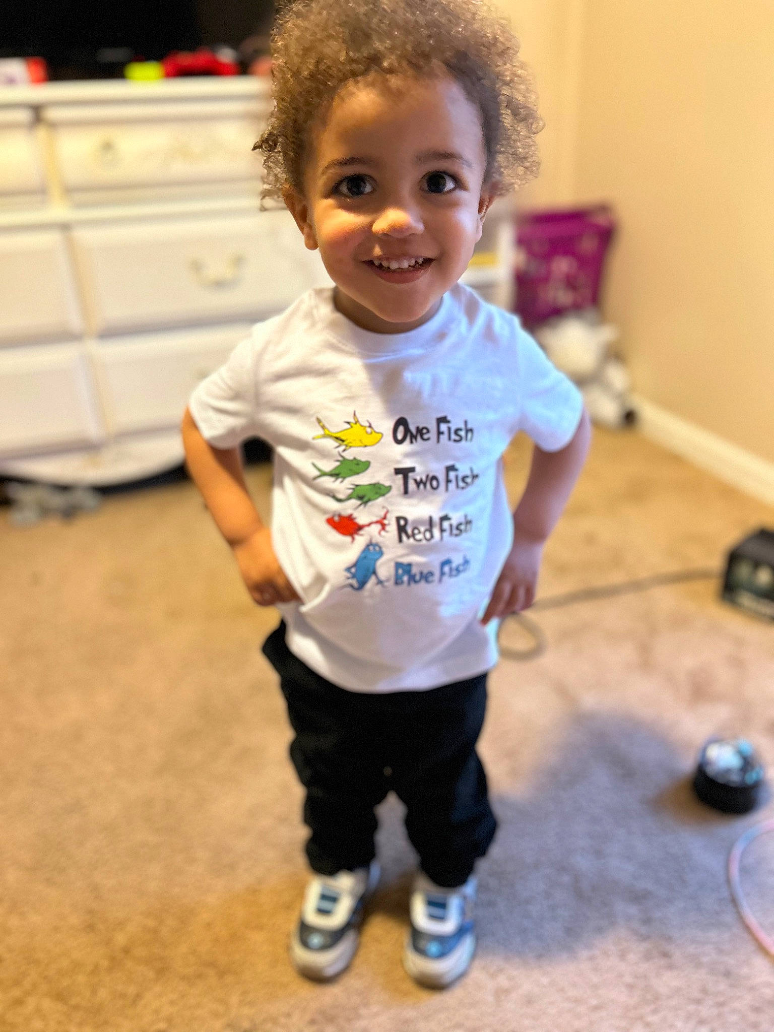 Jeremiah is registered to the contest to win money with this photo: baby, baby_toddler_clothing, child, face, floor, flooring, fun, hair, happy, head, joint, joy, nose, people, person, sleeve, smile, sportswear, standing, t_shirt