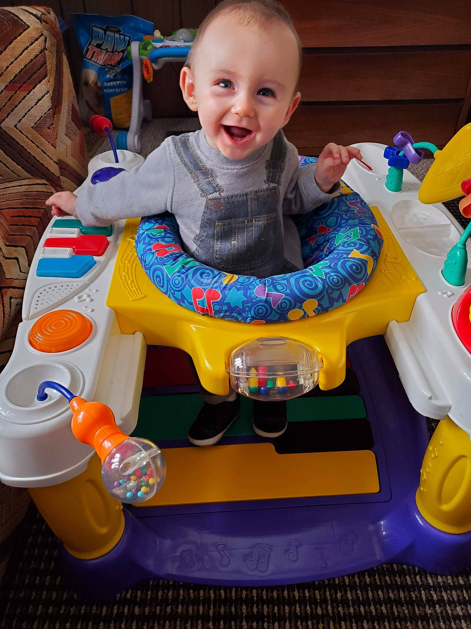 Odin is registered to the contest to win money with this photo: baby, baby_laughing, baby_playing_with_toys, baby_products, baby_toddler_clothing, baby_toys, child, eye, joy, lap, laugh, mouth, person, plastic, play, product, riding_toy, sitting, t_shirt, toddler
