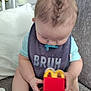 baby, infant, pacifier, bib, happy_meal, toy, couch, indoor, child, clothing, foot, hand, sitting, door, knob, curly_hair, smile, face, head, relaxed