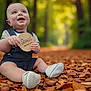 baby, child, seven_months, autumn, leaves, forest, denim_overalls, white_shoes, smiling, sitting, nature, outdoor, happy, portrait, cute, young_child, holding_sign, seasonal, fall, baby_clothing