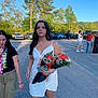 Paige is registered to the contest to win money with this photo: young_woman, dress, tiara, bouquet, flowers, outdoor, daytime, people, road, trees, car, jeans, shorts, casual_clothing, group, nature, sunny, blue_sky, celebration, walking
