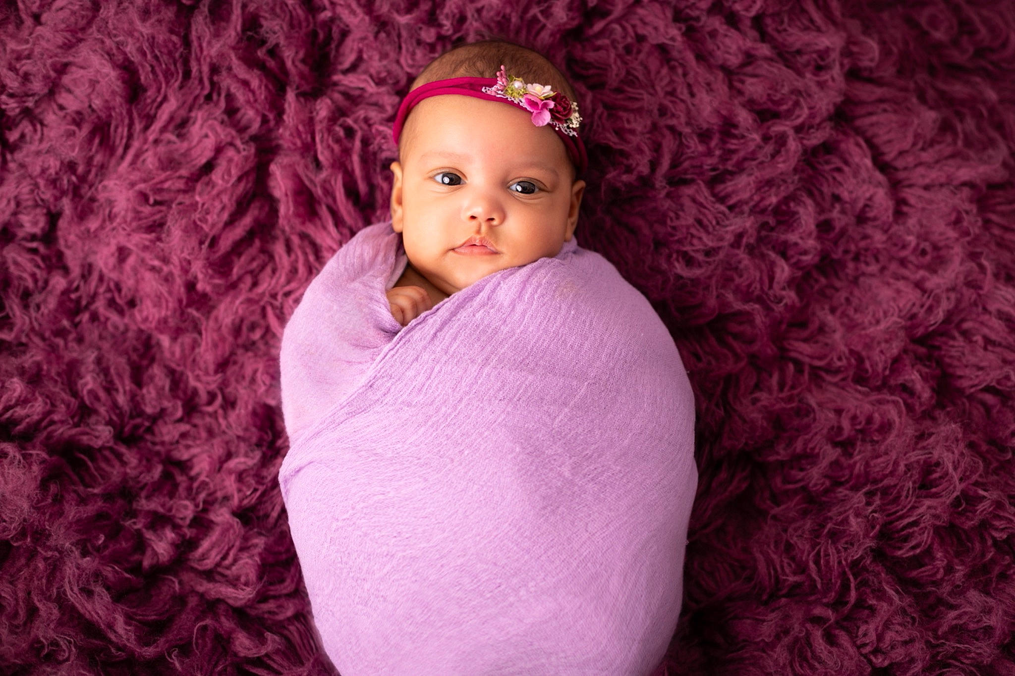 Maëlyne participe au concours pour gagner de l'argent avec cette photo : baby, brown_hair, cap, child, electric_blue, flash_photography, headwear, iris, knit_cap, lip, long_hair, magenta, pattern, person, pink, plant, purple, sitting, textile, toddler
