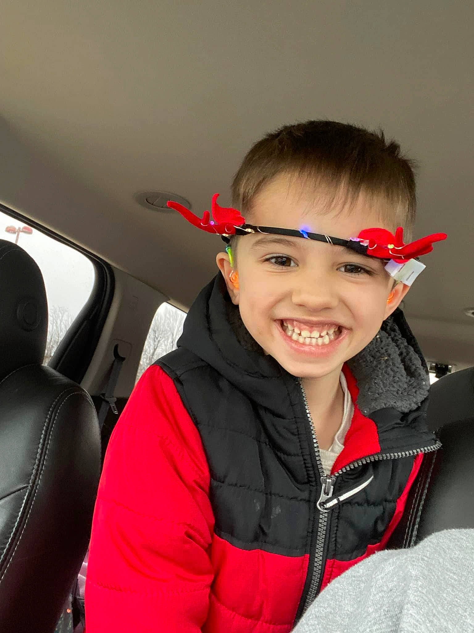 Dawson is registered to the contest to win money with this photo: auto_part, automotive_design, car, car_seat, car_seat_cover, child, face, family_car, fashion_accessory, fun, hairstyle, happy, head_restraint, joy, person, personal_luxury_car, personal_protective_equipment, smile, steering_wheel, toddler