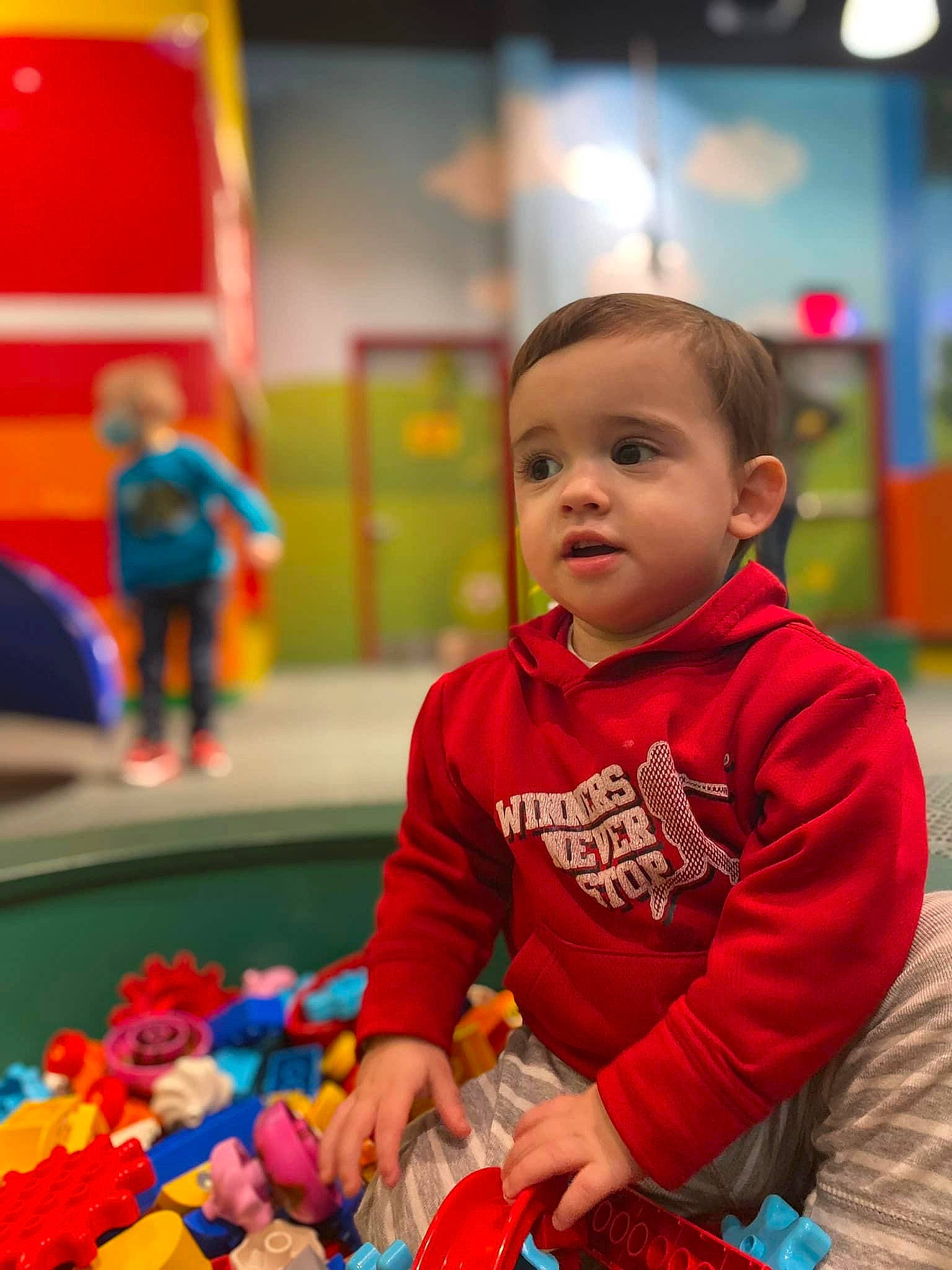 Jax is registered to the contest to win money with this photo: baby, baby_playing_with_toys, baby_toddler_clothing, child, event, flooring, fun, happy, kindergarten, leisure, person, play, recreation, red, room, sitting, snapshot, toddler, toy, toy_block