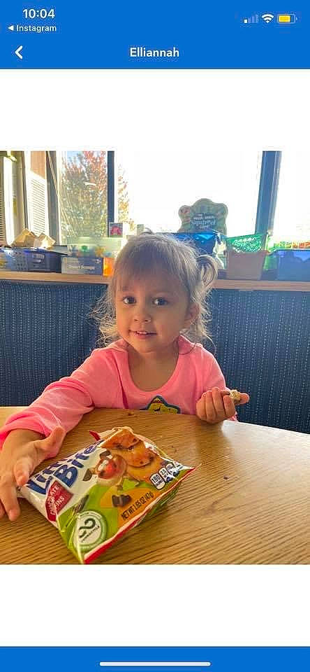 Ellie is registered to the contest to win money with this photo: baby, chair, child, comfort_food, dish, flooring, fun, happy, joy, junk_food, meal, person, play, room, sharing, sitting, smile, t_shirt, table, tableware