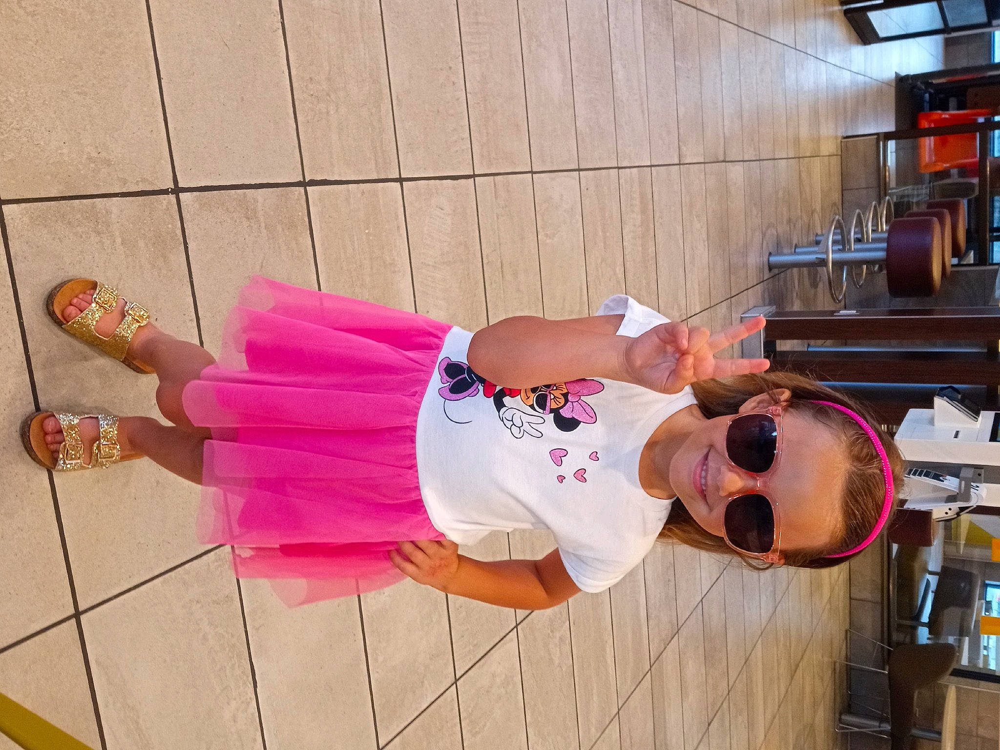 Nola is registered to the contest to win money with this photo: boot, costume, footwear, fun, hat, human_leg, joy, magenta, peach, person, sandal, shelf, shelving, smile, t_shirt, thigh, wood