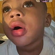 Za'Marii is registered to the contest to win money with this photo: child, face, closeup, video_call, adult, expression, indoor, person, head, communication, technology, screen, home, portrait, casual, white_clothing, earring, emotion, interaction, conversation