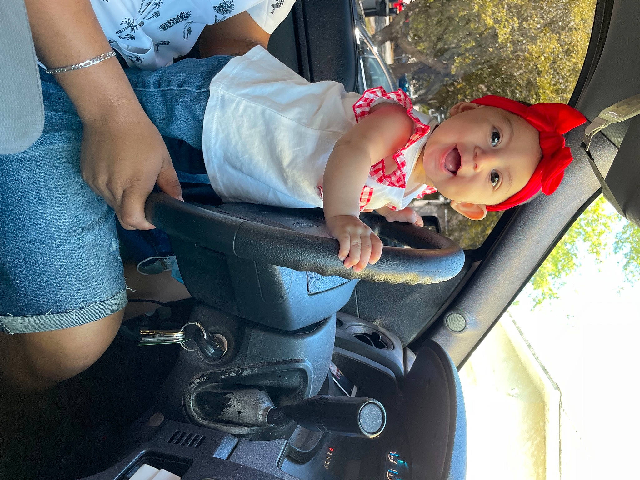 Addalyn is registered to the contest to win money with this photo: auto_part, baby, baby_carriage, baby_products, baby_safety, baby_toddler_clothing, car_seat, child, electric_blue, fun, hat, headwear, human_leg, lap, person, shorts, sitting, thigh, tire, toddler