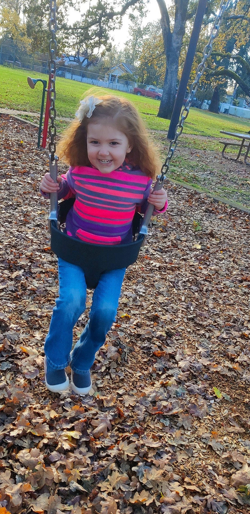 Summitt is registered to the contest to win money with this photo: child, city, electric_blue, fun, grass, happy, joy, leisure, outdoor_play_equipment, pattern, people_in_nature, person, plant, playground, recreation, sleeve, smile, soil, swing, toddler