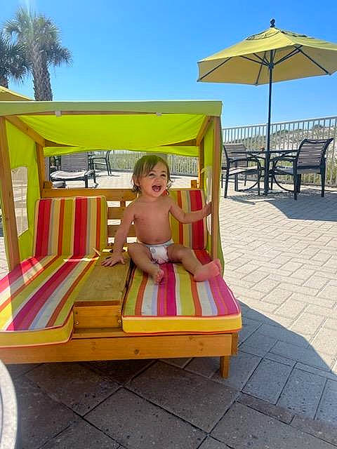Luna-ray joined the competition — help win amazing prizes! baby, comfort, fun, leisure, outdoor_furniture, outdoor_table, palm_tree, person, recreation, shade, shorts, sky, summer, sunlounger, swimwear, tire, toddler, travel, tree, umbrella