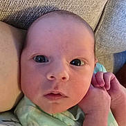 Everleigh joined the competition — help win amazing prizes! baby, newborn, infant, face, eyes, hand, couch, fabric, clothing, skin, person, portrait, cute, closeup, lying_down, soft, comfortable, indoors, expression, newborn_baby
