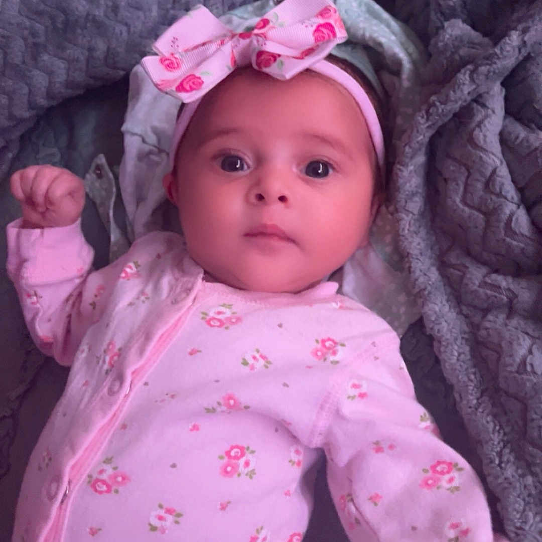 Mia joined the competition — help win amazing prizes! baby, bed, blanket, bodypart, bonnet, cap, clothing, dress, face, finger, furniture, hand, hat, head, hood, newborn, pajamas, person, photography, portrait