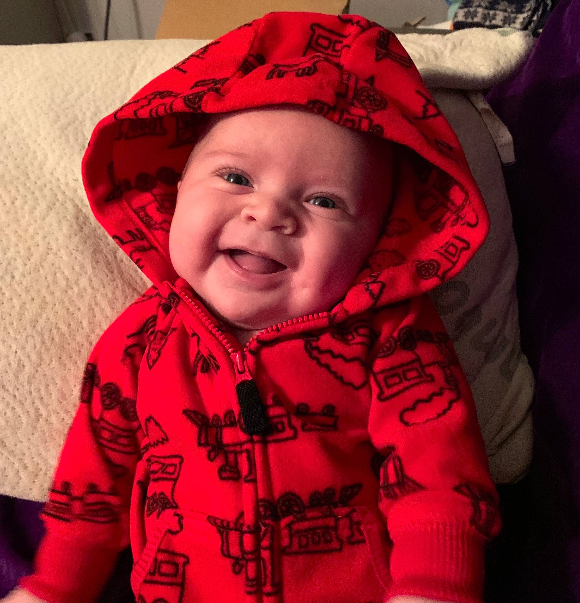Colin is registered to the contest to win money with this photo: baby, baby_laughing, baby_products, baby_toddler_clothing, bonnet, cheek, child, comfort, cool, headwear, hood, joy, laugh, linens, lip, person, pink, skin, sleeve, textile
