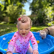 Blossom joined the competition — help win amazing prizes! toddler, child, swimsuit, pink_clothing, blue_pool, outdoor, summer, dog, pet, grass, garden, water, play, happy, cute, sunlight, nature, fun, baby, curly_hair
