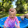 toddler, child, swimsuit, pink_clothing, blue_pool, outdoor, summer, dog, pet, grass, garden, water, play, happy, cute, sunlight, nature, fun, baby, curly_hair