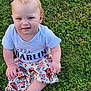 baby, child, grass, outdoor, sitting, shirt, skirt, dog_print, crossed_legs, barefoot, cute, young_child, nature, portrait, daylight, blue_eyes, short_hair, expression, clothing, person
