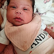 Jream is registered to the contest to win money with this photo: baby, bib, blanket, closeup, comfort, curly_hair, cute, face, hand, indoors, infant, newborn, person, portrait, resting, skin, sleepwear, soft, tender_moment, young_child