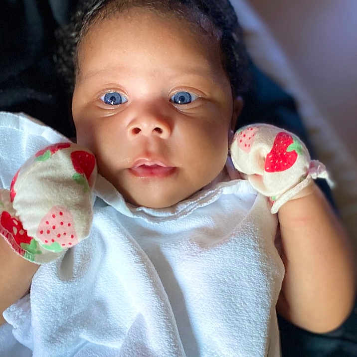 Jream joined the competition — help win amazing prizes! adorable, baby, blanket, blue_eyes, child, closeup, curly_hair, cute, expression, face, indoor, infant, mittens, newborn, portrait, skin, small_hands, soft_light, strawberry_pattern, white_clothing