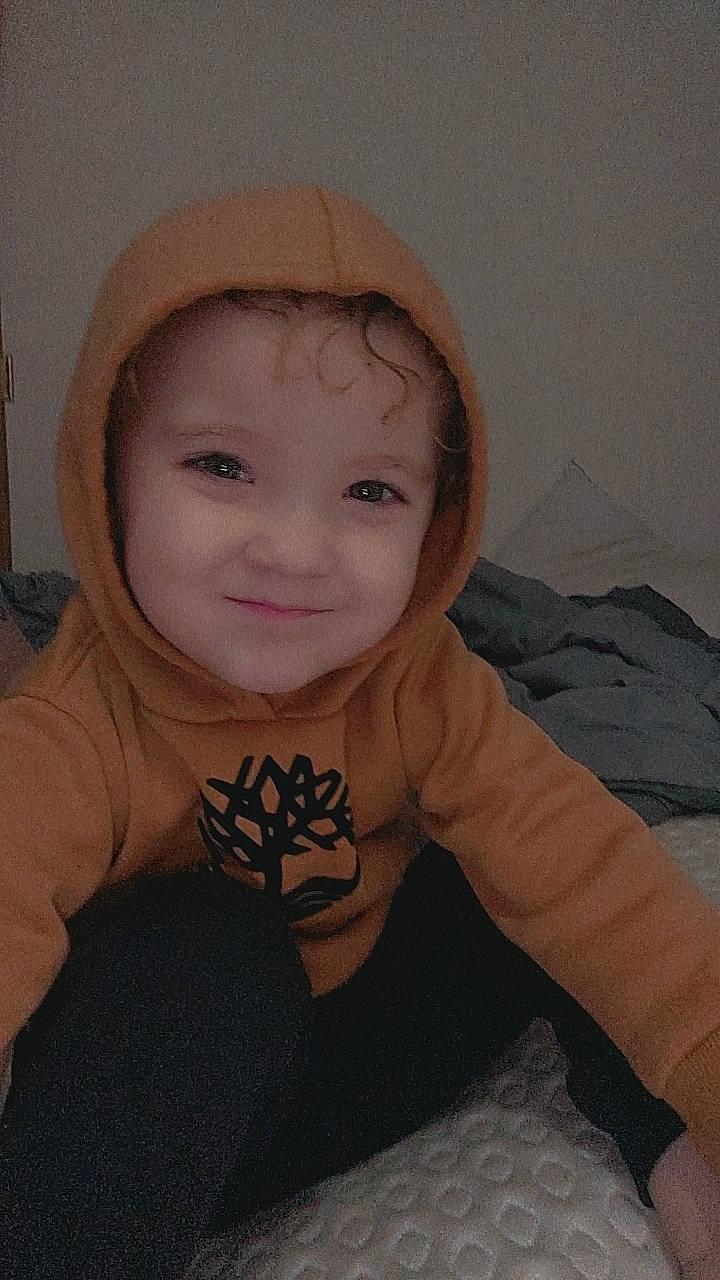 Amelia is registered to the contest to win money with this photo: baby, baby_toddler_clothing, cap, cheek, comfort, eye, eyebrow, face, flash_photography, happy, head, human_body, iris, joy, lip, mouth, nose, person, skin, sleeve