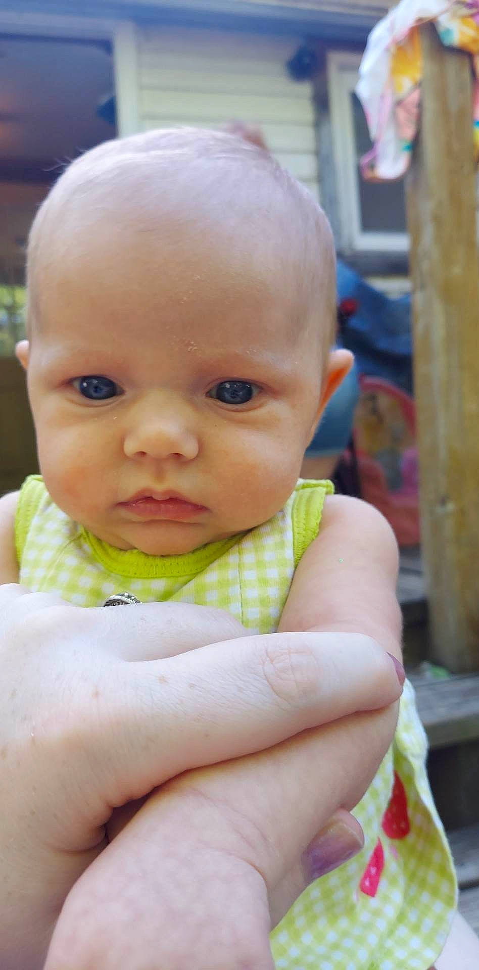 Gabriella joined the competition — help win amazing prizes! baby, baby_products, baby_toddler_clothing, cheek, child, chin, close_up, eye, eyelash, finger, grass, happy, iris, lip, nose, person, sitting, skin, smile, thumb