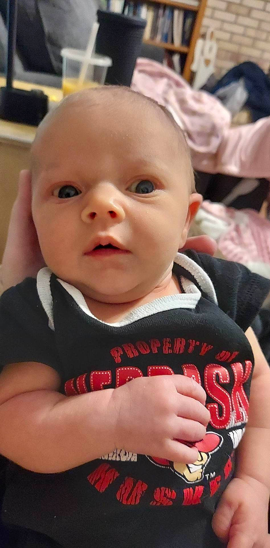 Gabriella is registered to the contest to win money with this photo: arm, baby, baby_toddler_clothing, carmine, cheek, child, eyelash, finger, fun, happy, iris, lip, nose, person, sitting, skin, sleeve, smile, t_shirt, thumb