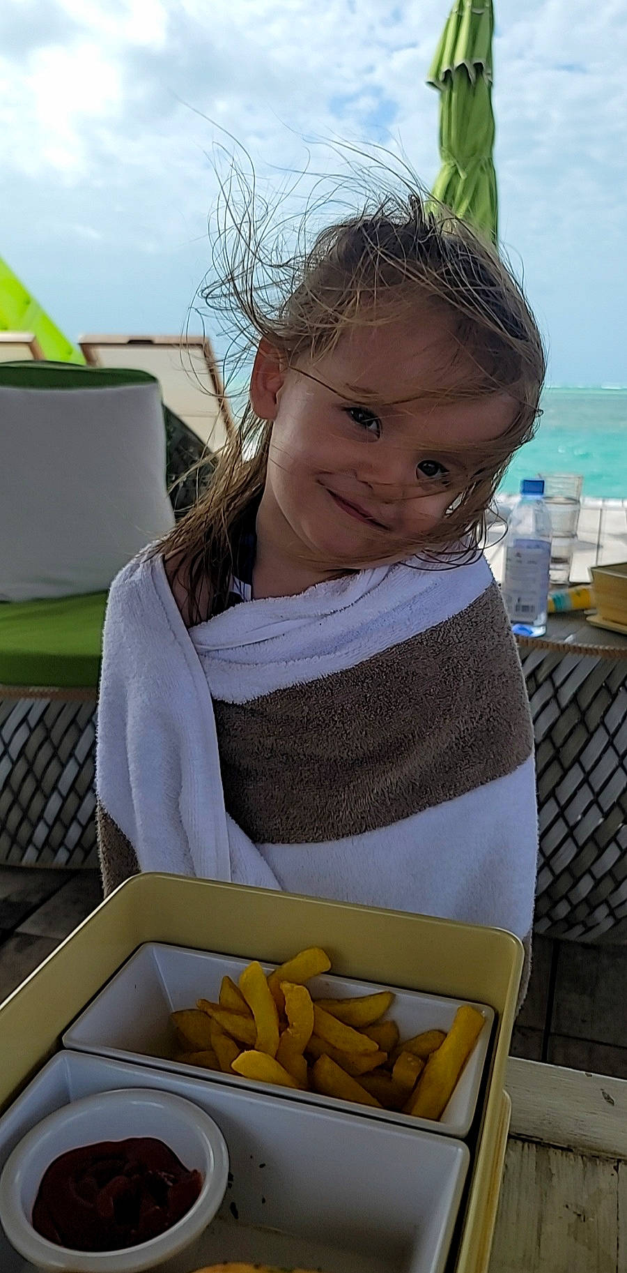 Freyja is registered to the contest to win money with this photo: banana_family, chair, child, comfort_food, cuisine, dish, finger_food, food, happy, ingredient, joy, junk_food, leisure, person, photograph, recipe, root_vegetable, sky, snack, tableware