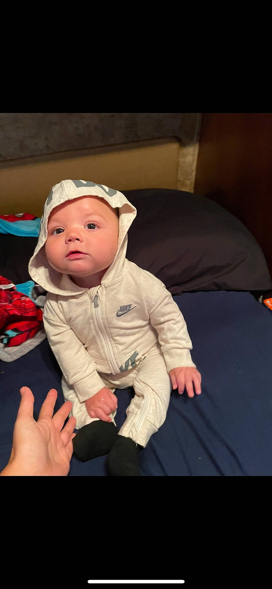 Oliver is registered to the contest to win money with this photo: baby, baby_toddler_clothing, cap, cheek, child, comfort, face, flash_photography, flooring, fun, gesture, happy, human_body, mouth, nose, person, sitting, skin, sleeve, thumb