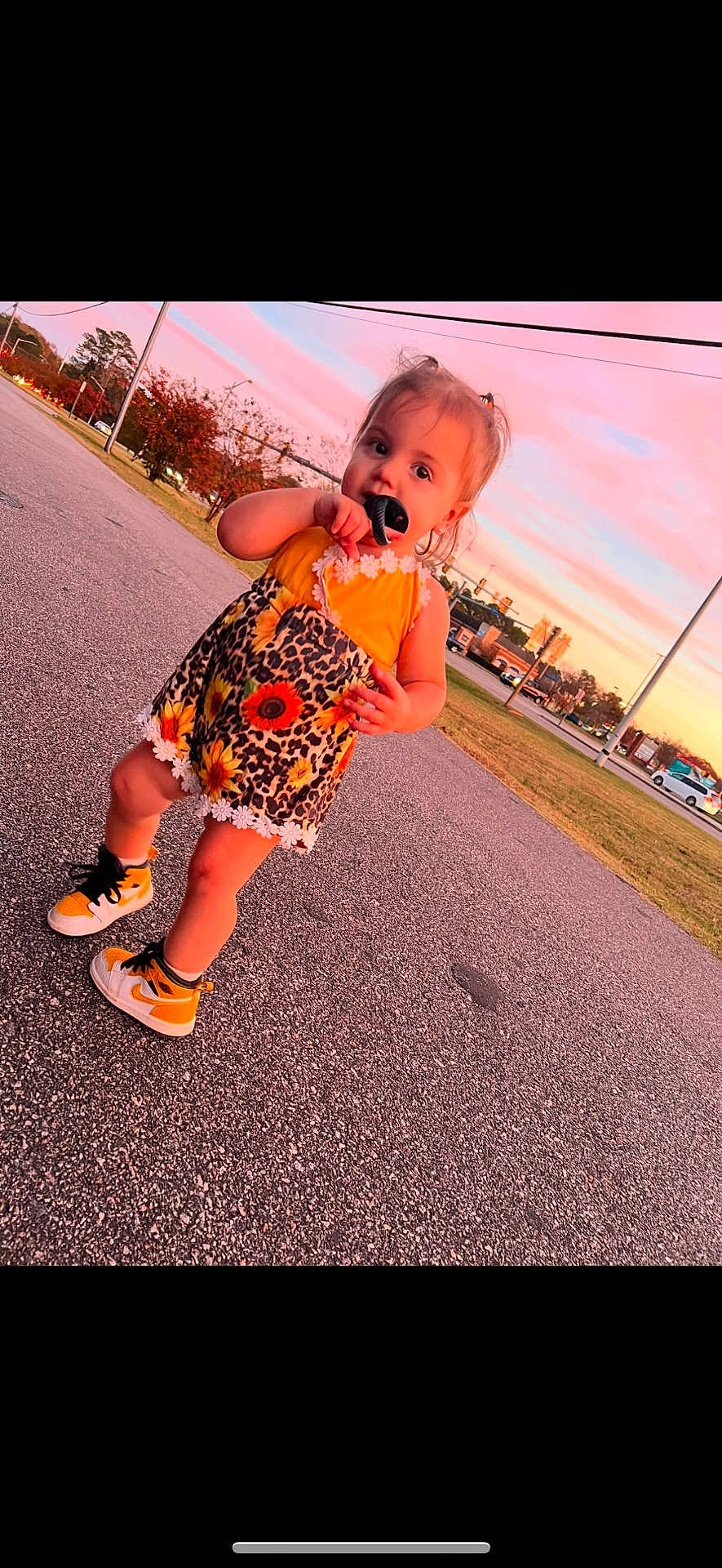 Oaklynn is registered to the contest to win money with this photo: toddler, child, street, sunset, sky, sneakers, yellow, dress, leopard_print, sunflowers, playing, outdoor, grass, trees, sidewalk, person, cute, fashion, hair_tie, daylight