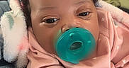 Khalia is registered to the contest to win money with this photo: baby, blanket, child, closeup, cozy, cute, cute_accessory, fabric, face, hand, headband, holding, indoor, infant, pacifier, person, pink_clothing, resting, sleepy, soft_toys