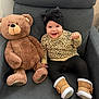 Estefany joined the competition — help win amazing prizes! baby, teddy_bear, armchair, smiling, headband, boots, sweater, leggings, plush_toy, indoor, child, cute, happy, seated, furniture, soft_toy, cozy, portrait, home, infant