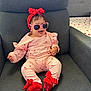 baby, infant, child, pink, red, sunglasses, headband, smile, happy, clothing, socks, bow, chair, furniture, indoor, cute, portrait, person, seat, cozy