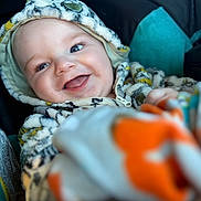 Carter Allen is registered to the contest to win money with this photo: adorable, baby, babywear, blanket, child, closeup, clothing, comfort, cozy, cute, face, happy, hoodie, indoor, infant, person, portrait, smiling, soft, warm
