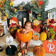 Ryan is registered to the contest to win money with this photo: baby, pumpkin, fall, autumn, scarecrow, decoration, holiday, cute, child, orange, yellow, green, plant, festive, indoors, smiling, seasonal, harvest, toy, floor