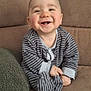 Tyrone participe au concours pour gagner de l'argent avec cette photo : baby, smiling, striped_pajamas, couch, beige, green_cushion, happy, indoor, child, person, infant, cute, sitting, cozy, plush, portrait, homedecor, comfort, face, hands