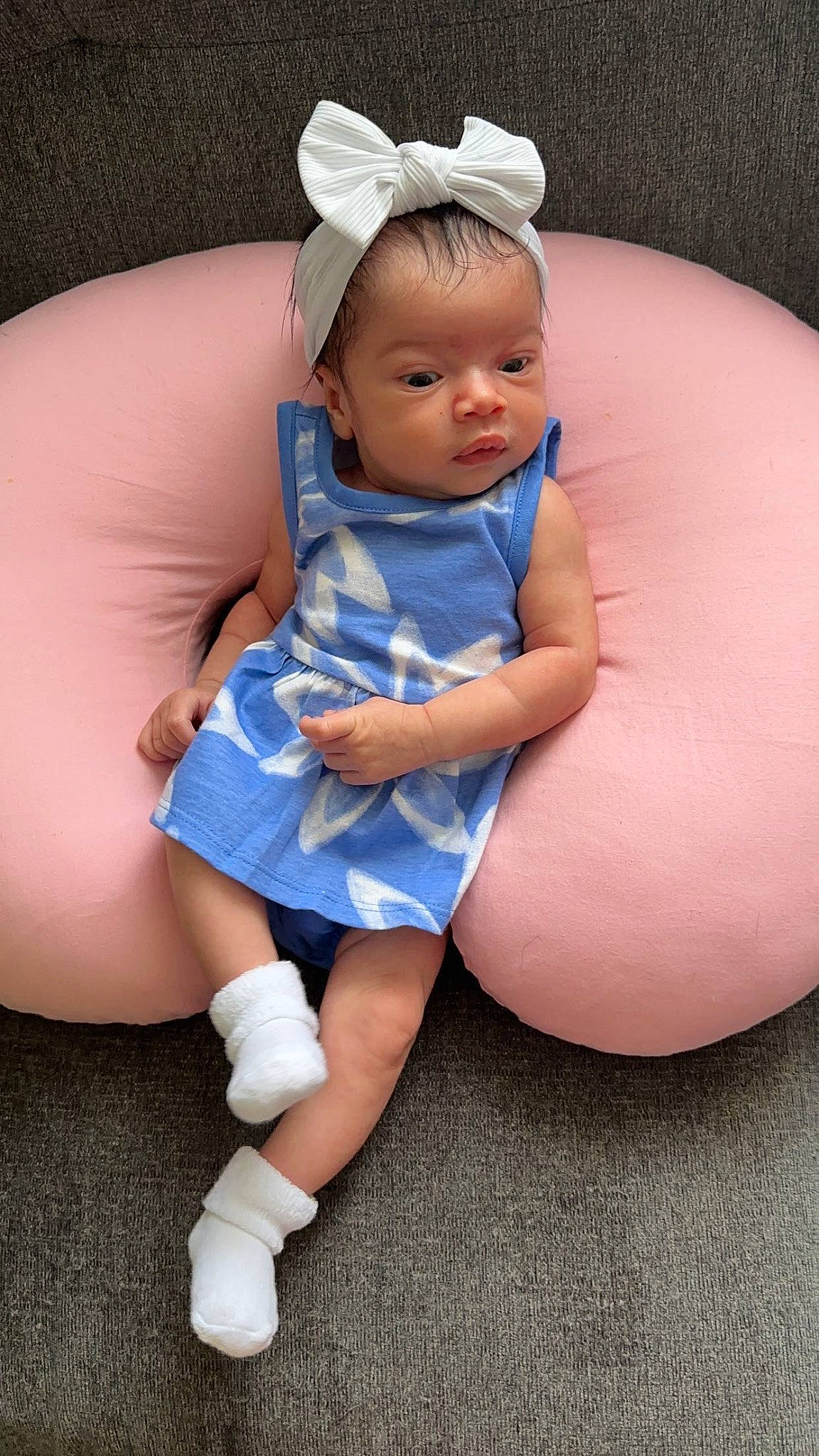 Alaia is registered to the contest to win money with this photo: baby, baby_toddler_clothing, child, comfort, dress, electric_blue, face, facial_expression, flash_photography, happy, headband, headpiece, human_leg, jewellery, knee, person, pink, sitting, skin, thigh
