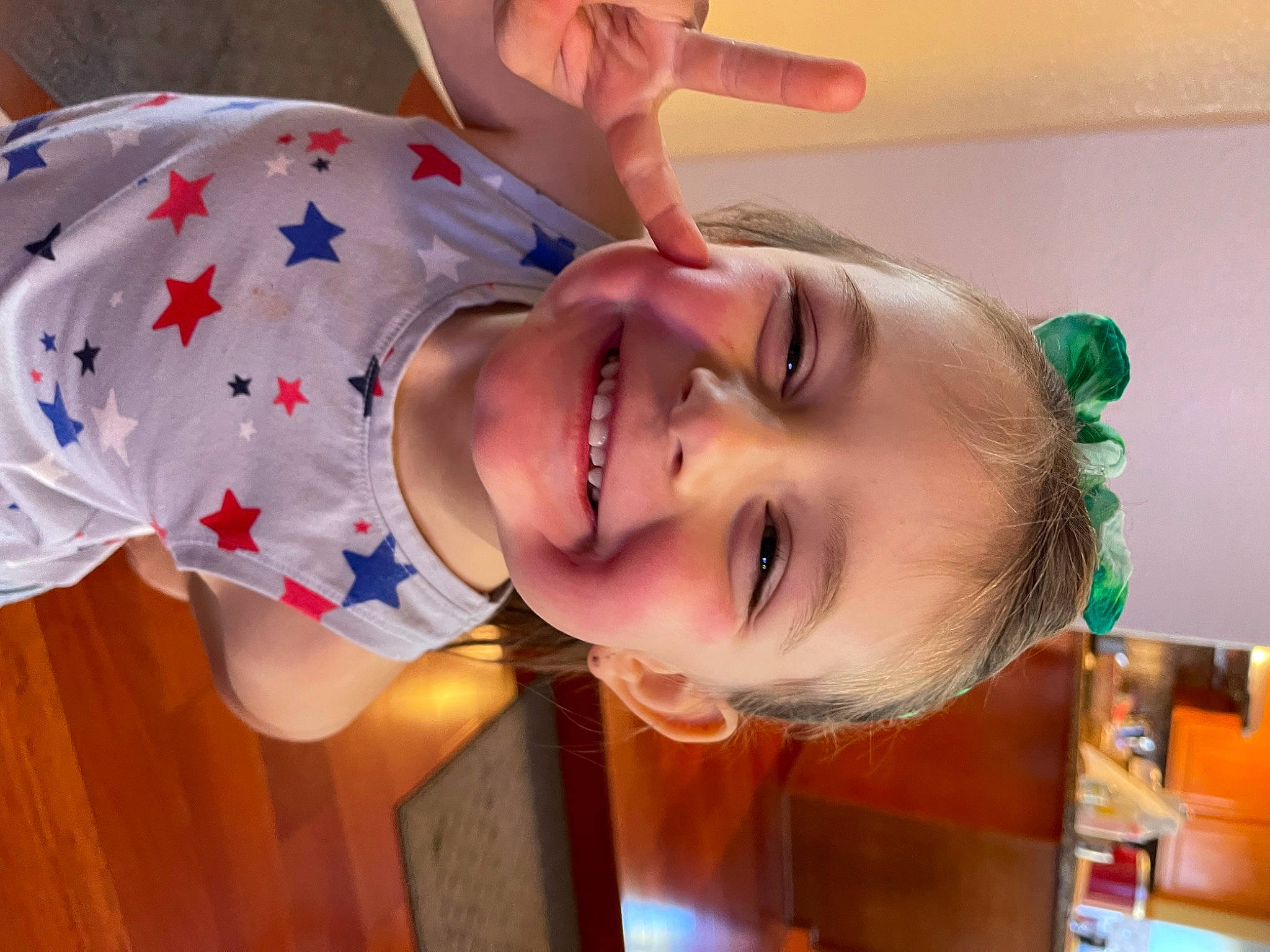 Rylie is registered to the contest to win money with this photo: chest, child, chin, eyelash, eyewear, fun, happy, hat, human_body, joy, lip, mouth, nose, orange, party, person, room, skin, smile, t_shirt