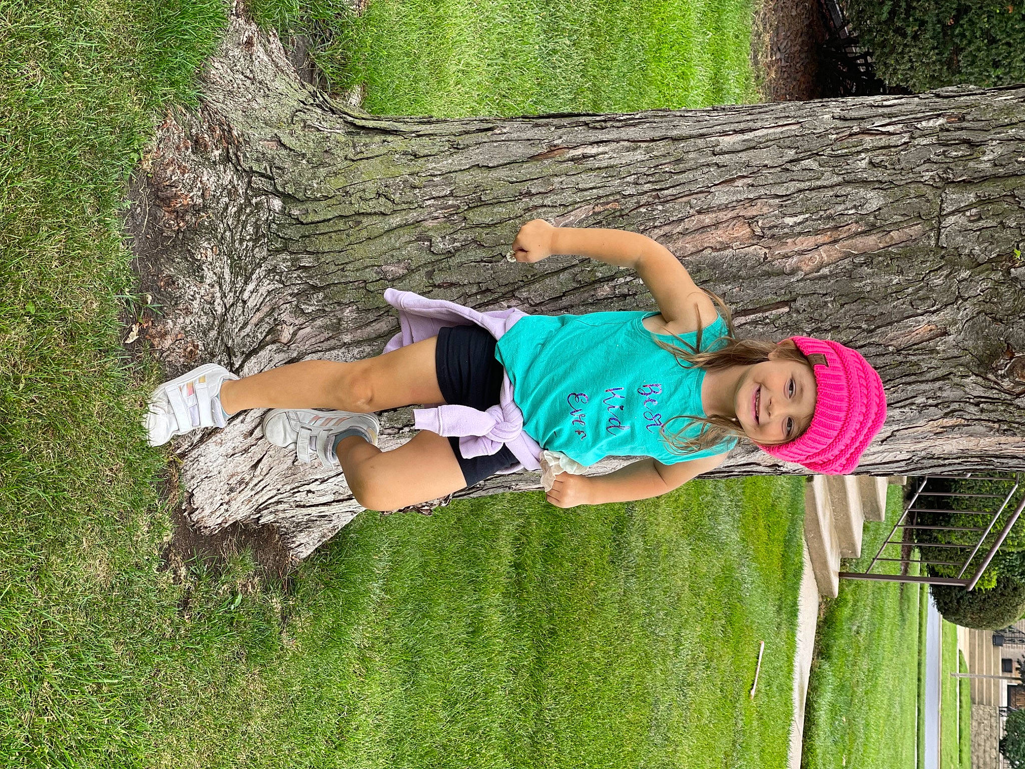 Rylie is registered to the contest to win money with this photo: elbow, fun, grass, grass_family, green, happy, headwear, human_leg, joy, knee, leisure, nature, people_in_nature, person, plant, recreation, shorts, t_shirt, thigh, tree