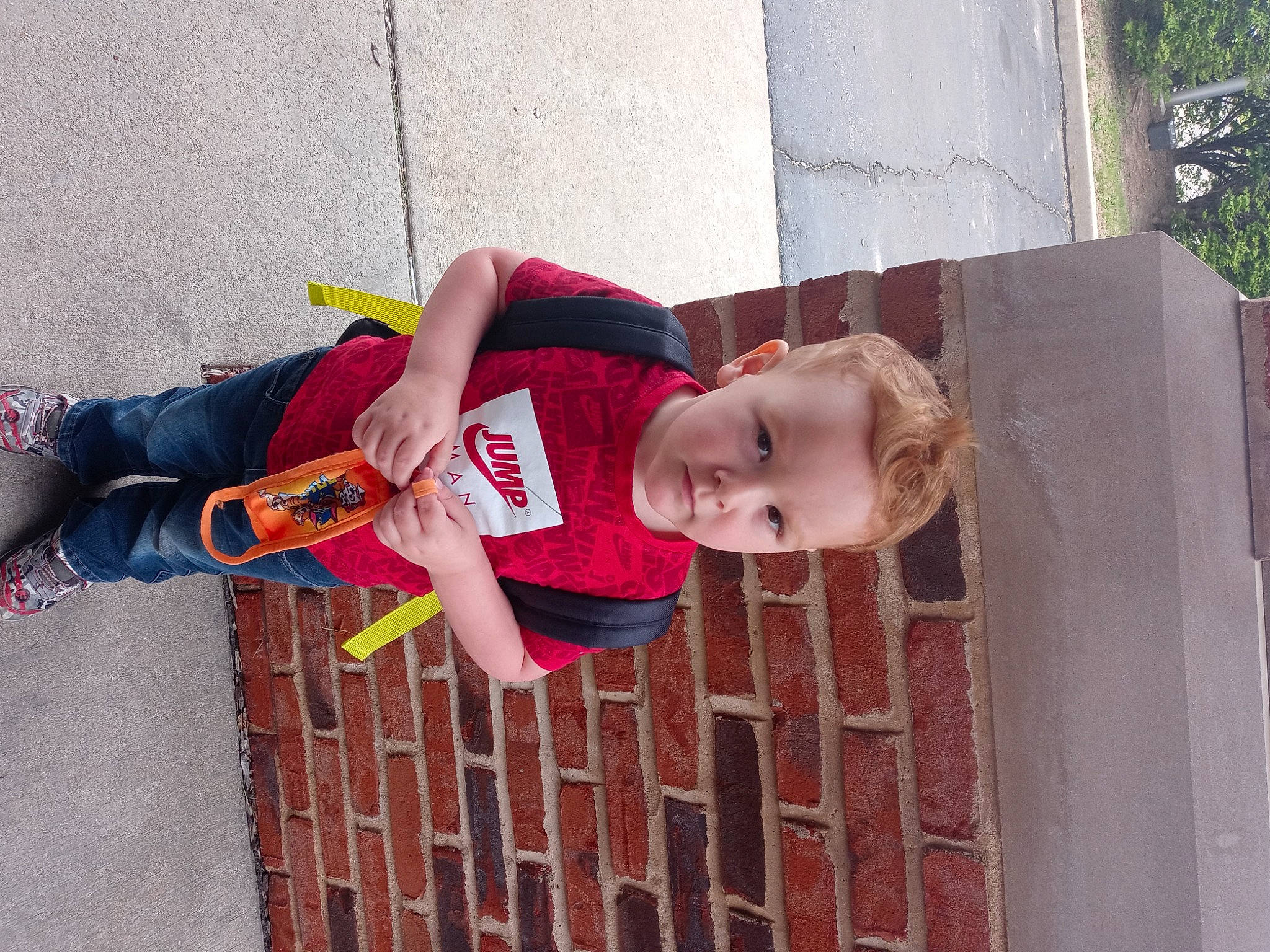 Jeffrey is registered to the contest to win money with this photo: baby_toddler_clothing, carmine, child, dress, fun, happy, joint, pattern, person, plant, red, smile, street_fashion, t_shirt, textile, toddler, tree, wood