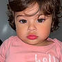 toddler, child, portrait, face, curly_hair, pink_shirt, expression, indoor, person, young_child, closeup, baby, cute, eyelashes, skin, clothing, head, looking_at_camera, human, casual