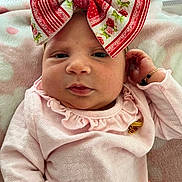 Alora joined the competition — help win amazing prizes! baby, infant, headband, bow, pink_clothing, bracelet, blanket, closeup, portrait, face, skin, cute, child, newborn, resting, soft_texture, indoor, sleepwear, young, adorable