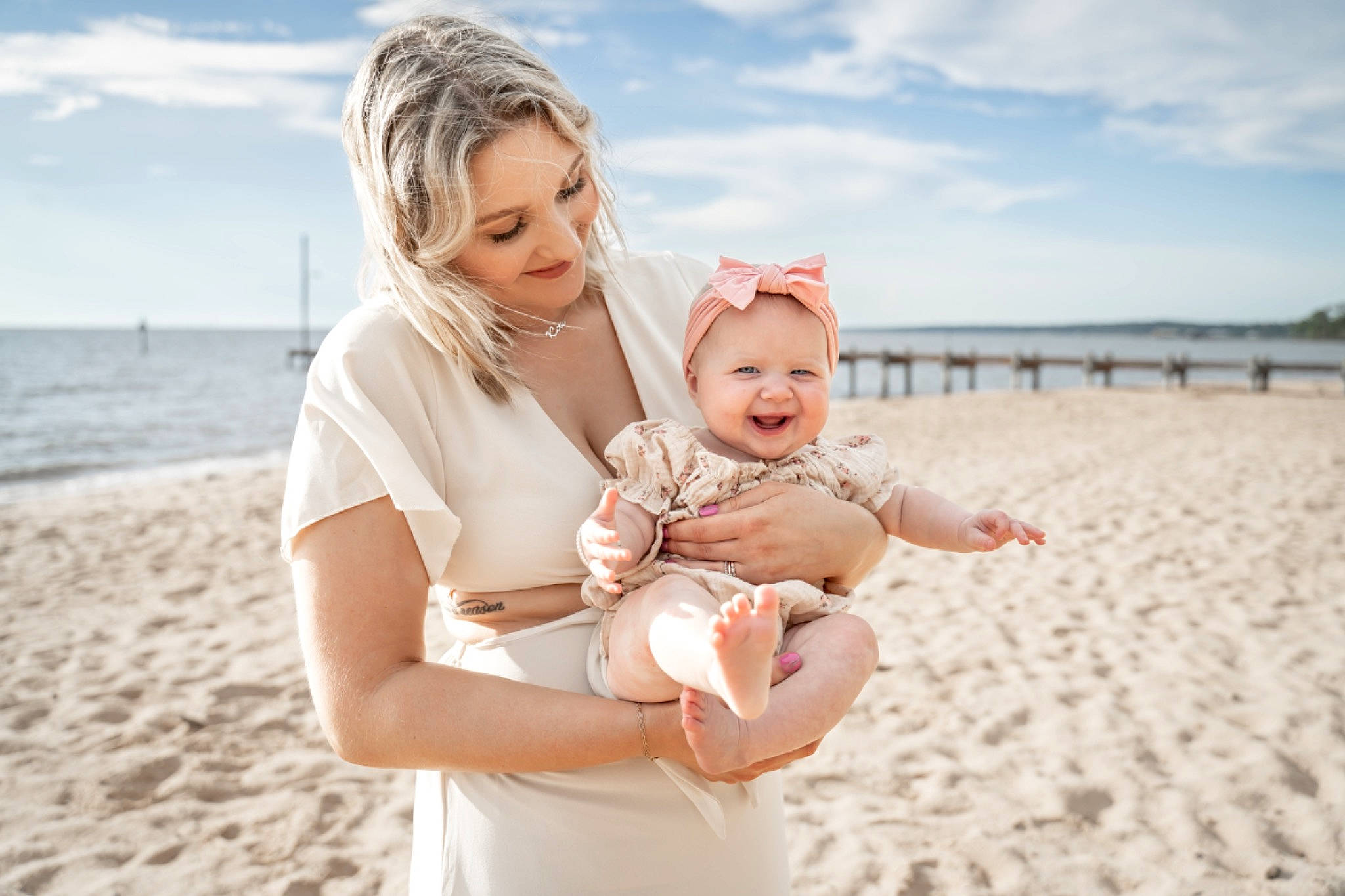 Katie is registered to the contest to win money with this photo: baby, beach, cloud, event, flash_photography, fun, gesture, hairstyle, happy, joy, people_in_nature, people_on_beach, person, playing_with_kids, sand, shore, sky, smile, summer, toddler