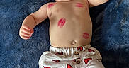 Piper is registered to the contest to win money with this photo: baby, infant, child, face, smile, kiss_marks, red_hearts, pants, white_clothing, blue_blanket, happy, joyful, open_mouth, raised_fists, lying_down, skin, cute, playful, portrait, indoors