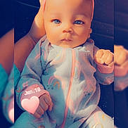 Jream is registered to the contest to win money with this photo: baby, infant, onesie, headband, pink, rainbow_pattern, hand, face, blue_eyes, cute, portrait, child, soft_lighting, indoor, person, newborn, sleepwear, expression, holding, love_text