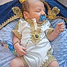 Mohamed Arifan participe au concours pour gagner de l'argent avec cette photo : baby, sleeping, crown, pacifier, blue_blanket, gold_trim, infant, clothing, hand, footwear, ornate, resting, cute, portrait, indoors, soft_texture, peaceful, person, newborn, accessory