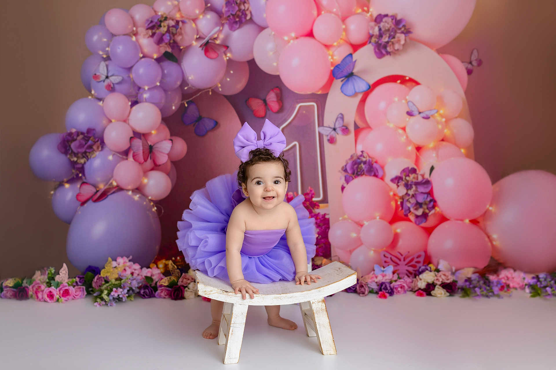 Francesca joined the competition — help win amazing prizes! child, baby, toddler, purple_bow, purple_tutu, balloons, pink_balloons, purple_balloons, butterflies, flowers, floral_arrangement, wooden_stool, studio_backdrop, birthday_theme, party_decor, fairy_lights, smiling, portrait, happy, decor